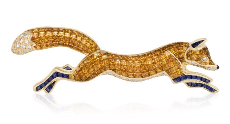 A brooch with orange and blue sapphires, and diamond accents. ©2020 Christie’s Images Limited.